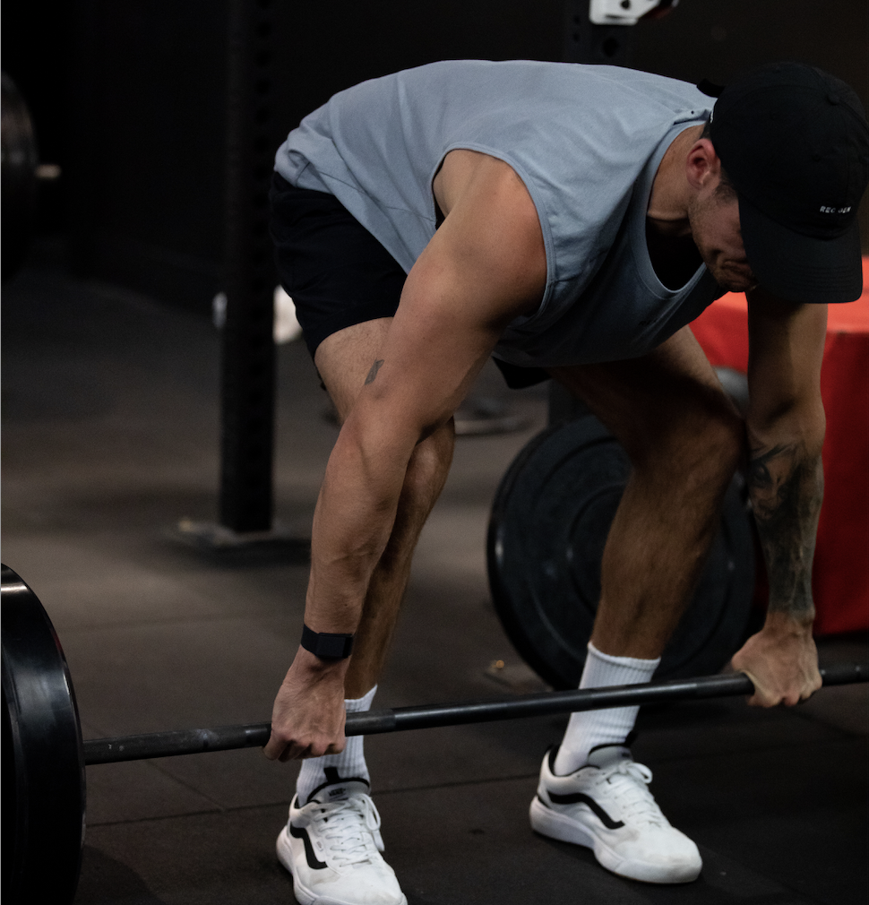 REVL member deadlifting on the training floor, black and white